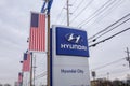 Hyundai car dealership sign with silver logo on a blue background