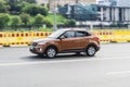 Hyundai Creta 2.0 AT driving on the city road on high speed. Brown Hyundai ix25 in motion on the highway