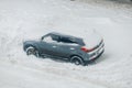 Hyundai Creta red car under snowdrift. Gray auto covered in snow. Wheel stuck in the deep snow Royalty Free Stock Photo