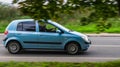 Hyundai Getz rides on rural highway. Cyan compact hatchback motor car rushes on the country road with blurred background Royalty Free Stock Photo