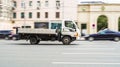 Hyundai hd35l light flatbed truck on the street in motion. Side view of a quality Korean lorry Royalty Free Stock Photo