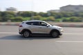 Hyundai Tucson Third generation TL car moving on the highway. Silver color SUV in motion