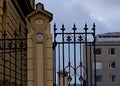 To the inner court leading black iron gate of the city hall on a cloudy springlike day