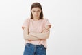 I am angry do not talk to me. Portrait of outraged offended cute female student, holding hands crossed on chest, looking
