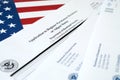 I-485 Application to register permanent residence or adjust status blank form lies on United States flag with envelope from