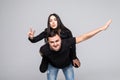I believe I can fly. Love story of attractive, funny, cheerful couple - handsome man carrying his lover on back like plane, woman Royalty Free Stock Photo