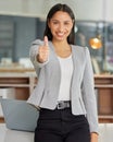 I believe in you and you should too. Portrait of a young businesswoman showing thumbs up in a modern office. Royalty Free Stock Photo