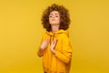 I am the best! Portrait of egoistic selfish curly-haired woman in urban style hoodie pointing herself