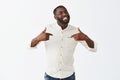 I am best. Portrait of good-looking confident and happy african american bearded guy with short haircut, pointing at