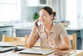 I better make that order now. an attractive young woman sitting alone and using her cellphone to work from home. Royalty Free Stock Photo