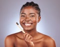 I brush and floss twice a day. Studio shot of a beautiful young woman brushing her teeth. Royalty Free Stock Photo