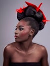 I came, I saw, I contoured. Studio shot of a beautiful young woman wearing Asian inspired makeup and posing with origami