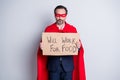 I can be your super man. Photo of stressed aged mature business guy super hero costume hold carton placard need job work