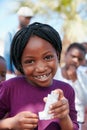 I can breathe easy now. Portrait of a little girl holding an asthma inhaler at a community outreach event.