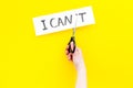 I can concept. Motivate youself, believe in yourself. Hand cut off the letter t of written word I can`t by sciccors Royalty Free Stock Photo