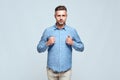 I can do everything. Confident and handsome man in casual clothes with closed fists near the chest standing against grey Royalty Free Stock Photo