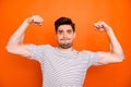 I can do it. Photo of self-assured guy raise fists arms showing strong biceps pushing hard diligent sportsman wear