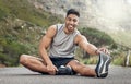 I can feel the difference after stretching. an athletic young man stretching on a mountain road.