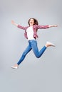 I can fly! Happiness, dream, fun, joy concept. Very excited happy cute brunette girl is jumping up, wearing casual clothes, white Royalty Free Stock Photo