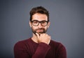 I can because I know who I am. Studio shot of a handsome young man looking smug against a gray background. Royalty Free Stock Photo