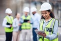 I can just check that on my tablet. a young female architect using a digital tablet at a building site. Royalty Free Stock Photo