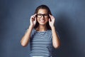 I can see clearly now. Studio portrait of an attractive young woman wearing glasses against a dark background. Royalty Free Stock Photo