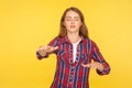 I can`t see! Portrait of ginger girl in checkered shirt walking with outstretched hands, blind or disoriented in darkness