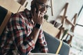 I can totally make it work! Handsome young man talking on his sm Royalty Free Stock Photo