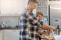 I can wait to taste our pizza. a father and his son making pizza at home. Royalty Free Stock Photo