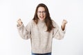 I cannot stand it anymore. Portrait of and fed up outraged young woman in glasses and sweater yelling in anger