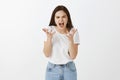 I cannot take it anymore. Portrait of stressed fed up and angry woman with dark hair, shouting and shaking palms