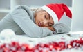 I cant keep up. a sleepy woman catching a nap at her desk in the office.