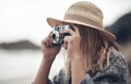 I cant think of a better way to spend my time. a young woman out at the beach with her camera.