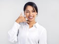 I cant wait to hear from you. Studio shot of a confident young businesswoman making a call me gesture against a grey Royalty Free Stock Photo