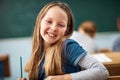 I cant wait to learn something new today. Portrait of an elementary school girl sitting in class. Royalty Free Stock Photo
