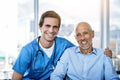 I care for my patients like family. Portrait of a male nurse caring for a senior patient. Royalty Free Stock Photo