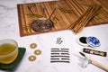 Close up of an I Ching arrangement with a handwritten Hexagram and different utensils