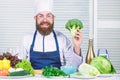 I choose only healthy ingredients. Man cook hat and apron hold broccoli. Healthy nutrition concept. Bearded professional Royalty Free Stock Photo