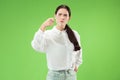 The overbearing business woman point you and want you, half length closeup portrait on green background. Royalty Free Stock Photo