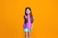 The happy teen girl pointing to you, half length closeup portrait on orange background. Royalty Free Stock Photo