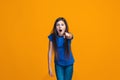 The happy teen girl pointing to you, half length closeup portrait on orange background. Royalty Free Stock Photo