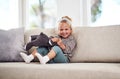 I could play with my toys all day. Full length portrait of an adorable little girl sitting alone on the sofa and playing Royalty Free Stock Photo