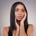 I could really use a change in style. an attractive young woman standing alone and looking contemplative while posing in Royalty Free Stock Photo