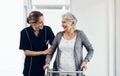 I couldnt have done it without your motivation. a female nurse assisting a senior woman using a walker. Royalty Free Stock Photo