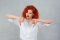 I dislike. Closeup portrait of unhappy angry mad pissed off redhead curly woman annoyed wife giving thumbs down gesture looking Royalty Free Stock Photo