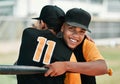 I do my best for my team. two young baseball players embracing each other while out on the pitch.