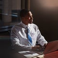 I do what needs to be done, today. a young man contemplating while using his laptop. Royalty Free Stock Photo