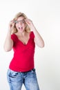 Portrait of shocked astonished blond woman with open mouth and big eyes Royalty Free Stock Photo