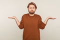 I don`t know! Portrait of clueless confused man with beard wearing sweatshirt shrugging shoulders Royalty Free Stock Photo