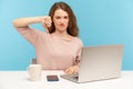 I don`t like! Displeased woman employee showing thumbs down, dislike gesture, expressing disapproval, sitting at workplace Royalty Free Stock Photo